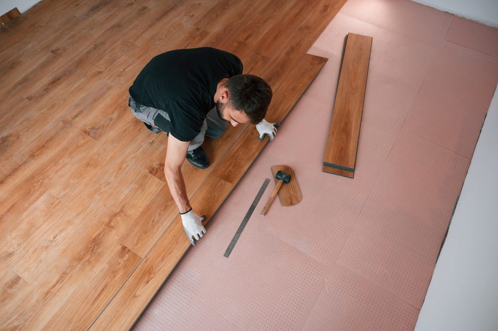 Installing new laminated wooden floor.