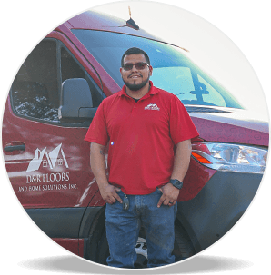 Homero Ortuno, owner of D&R Floors and Home Solutions in The Colony standing in front of their home remodeling van.